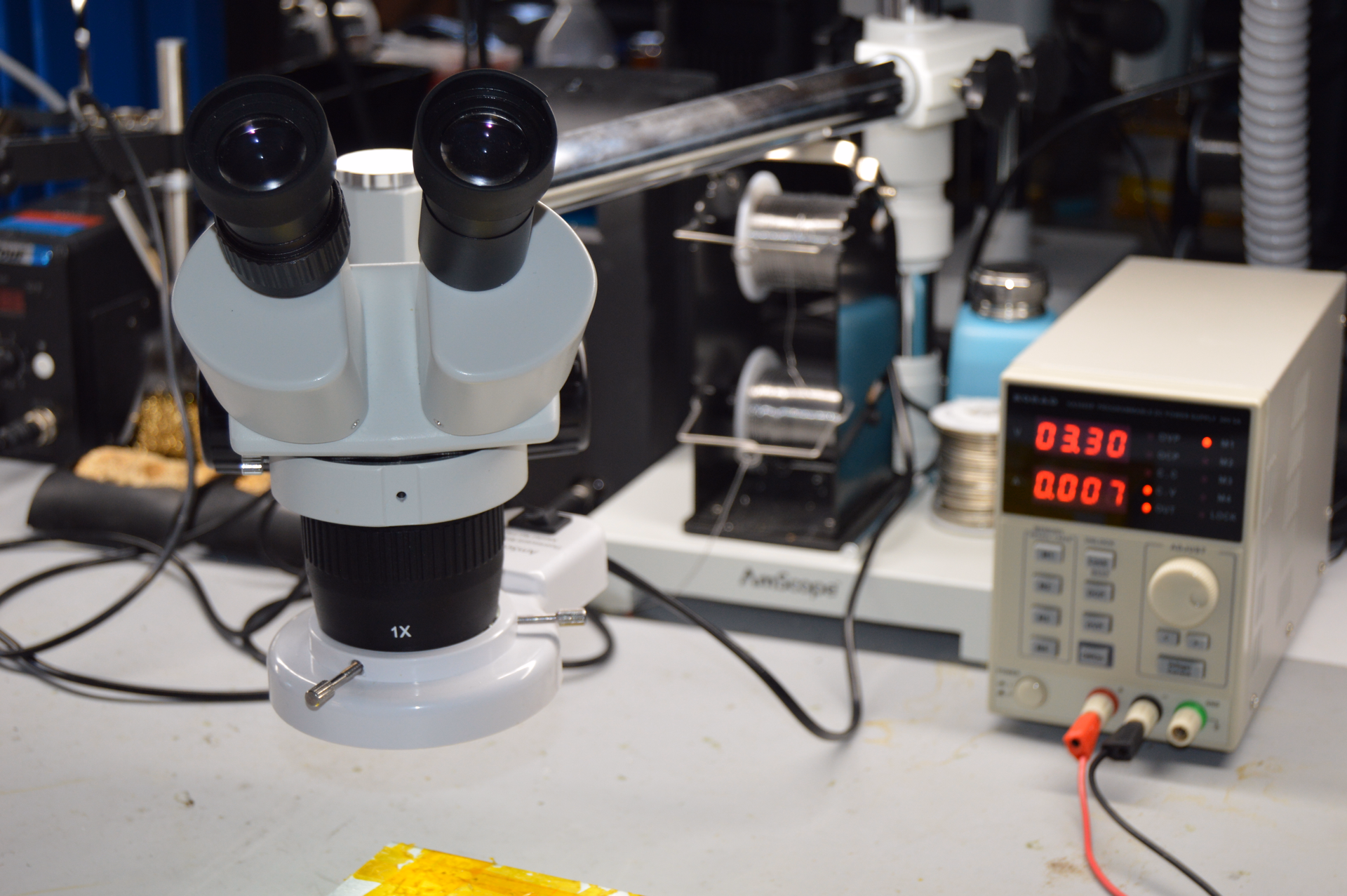 AmScope Microscope on laboratory table with results reading in the background